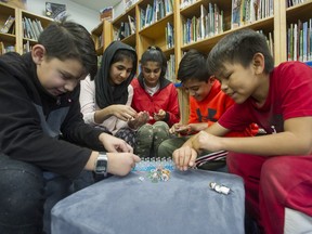 George Vanier Elementary students (from left) Alex Perez, Baryah Ahmad, Anureet Brar, Angad Kandola and Skyler Woods make friendship bracelets at the Surrey school last week.