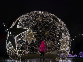 We can all open our hearts to a warm Christmas greeting, an unexpected gift or a dazzling light display, like the the giant ball of light that enchants this young visitor at the VanDusen Gardens 2018 Festival of Lights in Vancouver. Richard Lam/PNG