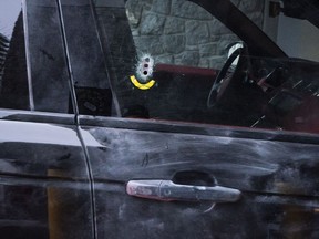 Three bullet holes are seen in the passenger window of a black Range Rover while it is removed from the parkade of the Compass condo at 680 Seylynn Crescent where a shooting occurred in the parkade of the building in North Vancouver, on December, 25, 2018.