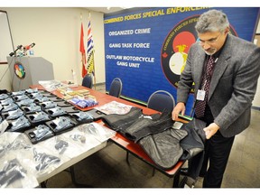 Tributes from across B.C.'s policing community poured in on Christmas Eve after a well-known and respected retired Abbotsford officer was identified as a victim in a Nanaimo car crash. Here, starter pistols, other firearms and these personal body armour displayed by Sgt. Shinder Kirk were laid out before the media during a Combined Forces Special Enforcement Unit press conference March 2, 2011 in Delta, in this file photo.