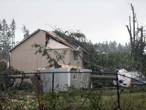 A home that was damaged near the Walmart in Port Orchard, Wash., on Tuesday, Dec. 18, 2018, after a tornado touched down. A rare tornado touched down in a Seattle suburb on Tuesday, damaging several homes and toppling trees, authorities said.  (Larry Steagall/Kitsap Sun via AP) ORG XMIT: WABRE106
