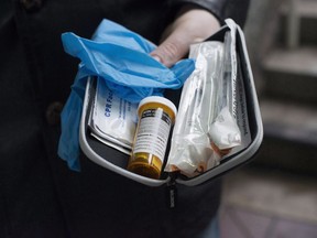 A new report being released Thursday is expected to outline a possible model for legally regulated heroin sales. A naloxone anti-overdose kit is shown in Vancouver in this file photo taken Friday, Feb. 10, 2017.