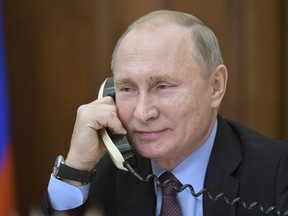 Russian President Vladimir Putin speaks on the phone with a teenager who visited a presidential plane to film its interiors in Luhansk, Russia, Tuesday, Dec. 25, 2018. Russian President Vladimir Putin speaks on the phone with a teenager who visited a presidential plane to film its interiors in Luhansk, Russia, Tuesday, Dec. 25, 2018.