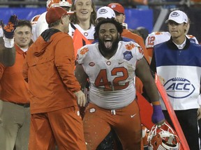 Clemson's Christian Wilkins laughs with head coach Dabo Swinney in the closing seconds of the Atlantic Coast Conference championship game against Pittsburgh in Charlotte, N.C., on Dec. 1, 2018. Clemson won 42-10 to take its fourth consecutive ACC championship game.