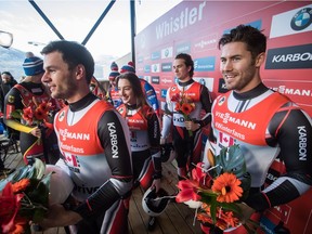 Canada's Reid Watts, from left, Kyla Graham, Justin Snith and Tristan Walker hold flowers after finishing third in a World Cup luge relay event in Whistler on Saturday, Dec. 1, 2018.