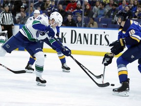 Elias Pettersson shoots to score past St. Louis Blues' Jay Bouwmeester during the first period.