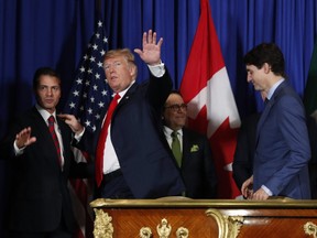 President Donald Trump, Prime Minister Justin Trudeau, right, and Mexico's now-former President Enrique Pena Nieto, left, walk out after participating in the USMCA signing ceremony, Friday, Nov. 30, 2018 in Buenos Aires, Argentina.