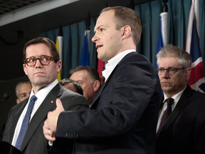 Standing Committee on Access to Information, Privacy and Ethics Chair MPs Bob Zimmer, left, Nathaniel Erskine-Smith, middle, and Charlie Angus from the Standing Committee on Access to Information, Privacy and Ethics at a news conference in Ottawa, Dec. 11, 2018.