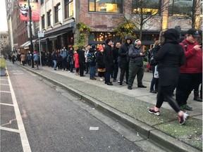 VANCOUVER, B.C.: DEC. 3, 2018 – A crowd can be seen lined up on Beatty Street in Vancouver, B.C. on Dec. 3, 2018 near TransLink's Compass Customer Service office at Stadium-Chinatown station. The crowd was awaiting the sale of TransLink's Compass wristbands. A first batch of 2,000 were made available on Monday, with the next shipment due in February. [PNG Merlin Archive]