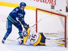 Vancouver Canucks' Elias Pettersson, left, of Sweden, scores on a penalty shot against Nashville Predators goalie Pekka Rinne, of Finland, during second period NHL hockey action in Vancouver on Thursday, Dec. 6, 2018.