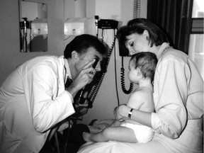 Dr. Michael Klein examining a baby. After heading the department of family medicine at McGill University for 17 years, Klein was appointed head of the department of family practice at B.C. Children's and Women's Hospital.