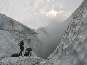 Climate change is causing glaciers atop Mount Meager, in British Columbia, to shrink increasing the chances of landslides and even a new eruption, says one expert. Team members from Simon Fraser University work on a study of fumaroles, or gas vents, on Mount Meager near Pemberton in a 2016 handout photograph.