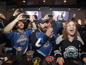 Ryan Kelly, left, Otto Rogers and Rebecca Moloney cheer the announcement of a new NHL hockey team in Seattle at a celebratory party Tuesday, Dec. 4, 2018, in Seattle. The NHL Board of Governors unanimously approved adding Seattle as the league's 32nd franchise on Tuesday, with play set to begin in 2021 to allow enough time for arena renovations.
