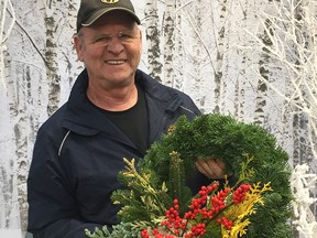 Jan Van Wijk with the Noble fir wreath he created using accents of ‘Yellow Ribbon’ cedar, Boulevard cypress, Hinoki cypress, Pinus parviflora, variegated cryptomeria and the berries of Ilex verticillata.