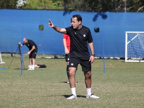 Phillip Dos Santos was hired as an assistant coach by the Vancouver Whitecaps on Friday, where he'll work under his older brother Marc.