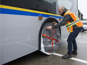 A special weather statement calling for snow and frosty road conditions is in effect on Sunday afternoon and TransLink is prepared. In this Nov. 1, 2018 file photo, TransLink engineer Simon Agnew demonstrates some of the tire socks to be used this winter on buses during snowfall.