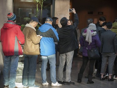 Huawei executive Meng Wanzhou appeared in BC Supreme Court in Vancouver, Dec. 7, 2018 for a bail hearing. Pictured is a man using a cell phone to take pictures inside the courthouse. Pictures are not allowed in Canadian courthouses.