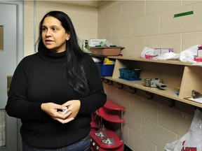 Vanessa Mani, an inner city outreach worker in action redistributing weekend food parcels for impoverished families at Lord Selkirk School in Vancouver, BC., December 12, 2018.