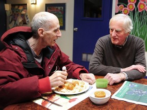 Tom Watterson, right, a retiring palliative care physician, chats with Raymond this week at May's Place — a DTES hospice.