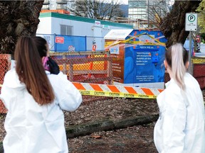 Clean up crew in action as the B.C. Coroners Service investigates after a man in his mid-30s who was stuck in a clothing donation bin and was pronounced dead at Ambleside Park in West Vancouver, BC., December 31, 2018. Police say the man was found by a passerby Sunday morning.