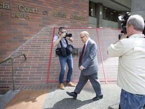 File: Special prosecutor David Butcher (centre) arrives at the B.C. Provincial court for Brian Bonney's case on May 17, 2016.