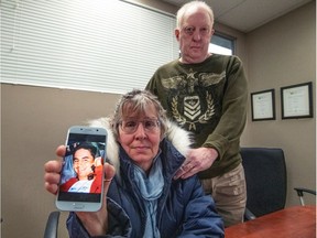 Mom Karen Juergens and stepfather Ken Stevenson with a photo of their late son, Darren Robinson.