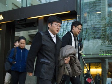 People leave the B.C. Supreme Court  on December 07 2018 after the bail hearing for Huawei's Meng Wanzhou was adjourned to Monday.