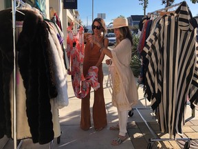Lisa Martinez (left) shows a vintage dress to Keirstin Selvage at Selvage Boutique in Hermosa Beach.