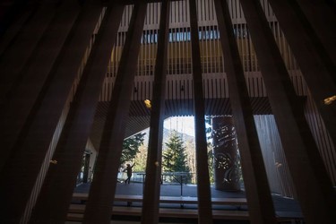 A woman stands outside the entrance to the Audain Art Museum in Whistler.