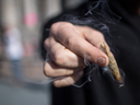 A man holds a joint while celebrating the legalization of recreational cannabis, in Vancouver, on Oct. 17, 2018.