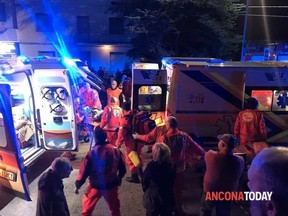 Rescuers assist injured people outside a nightclub in Corinaldo, Italy, early Saturday, Dec. 8, 2018.