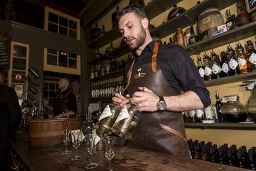 Joeri Remeeus shows some types of jenever inside the tasting house Wynand Fockink.