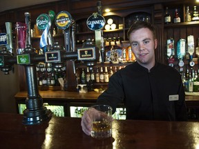 Serving a whiskey inside the Bushmills Inn.