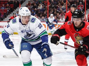 Maxime Lajoie of the Ottawa Senators defends against Bo Horvat.