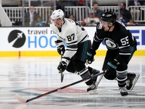 Sidney Crosby of the Pittsburgh Penguins and Mark Scheifele of the Winnipeg Jets race for possession during the 2019 Honda NHL All-Star Game at SAP Center on January 26, 2019 in San Jose, California.