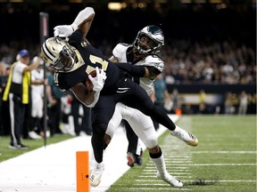 Alvin Kamara of the New Orleans Saints is pushed out of bounds by Avonte Maddox of the Philadelphia Eagles during the fourth quarter.