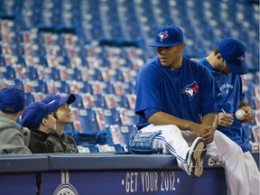 Former Blue Jays' pitcher Ricky Romero chats with a group of young fans as Toronto takes batting practice.