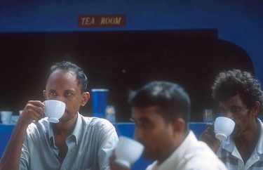 Locals drinking tea at a roadside stall.