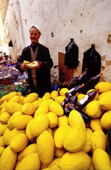 A wind angle lens forges a foreground-background relationship. Melon seller in Fez, Morocco.