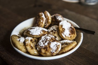 An authentic culinary highlight of Amsterdam are poffertjes, which are sugary mini pancakes.  Albert Cuypmarkt.