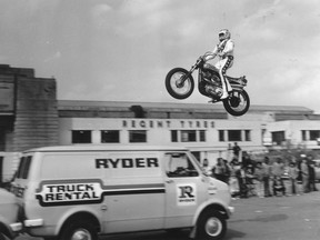 American stuntman Evel Knievel practising jumping over three vans in the car park of Wembley Stadium.