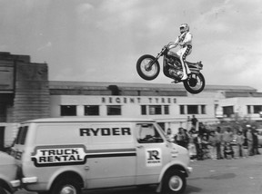 American stuntman Evel Knievel practising jumping over three vans in the car park of Wembley Stadium.