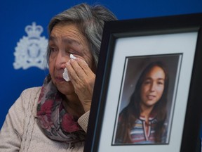 File photo: Madeline Lanaro, whose daughter Monica Jack was 12 years old when she was murdered in 1978 near Merritt, B.C., wipes away tears after the RCMP announced an arrest in connection with her murder during a news conference in Surrey on Dec. 1, 2014.