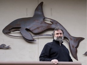 Salmon researcher Greg Ruggerone in front of an orca sculpture near his office on Friday in Seattle.