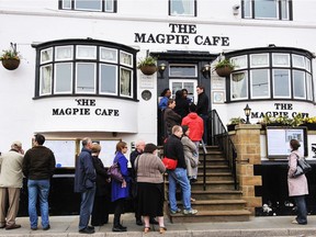 Customers queue outside the Magpie Café in Whitby, Yorkshire.