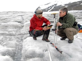 Professor Brian Menounos and a student measure changes in glacier thickness.