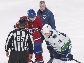 Montreal Canadiens' Jesperi Kotkaniemi (15) talks with Vancouver Canucks' Elias Pettersson (40) after taking him down in the second period.