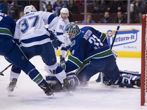 Vancouver Canucks goaltender Anders Nilsson (31) stops a shot from Tampa Bay Lightning center Yanni Gourde (37) during first period NHL action at Rogers Arena in Vancouver, Tuesday, Dec. 18, 2018.