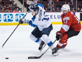 Aleksi Heponiemi of Finland manoeuvres past Switzerland's Justin Sigrist during Friday's semifinal action in the World Junior Hockey Championship at Rogers Arena in Vancouver. Finland will play the United States on Saturday night for the gold medal, while Russia will play Switzerland in the bronze-medal game Saturday afternoon.