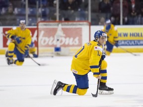Sweden's Samuel Fagemo (11) joins teammates reacting to their loss following third period IIHF world junior quarter-final hockey action against Switzerland, in Victoria, Wednesday, Jan. 2, 2019.
